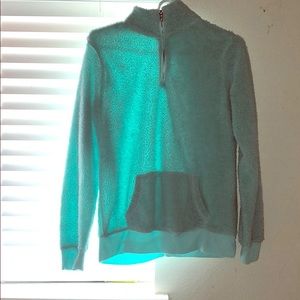 A mint green zip-up cozy jacket.